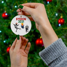 Load image into Gallery viewer, Byedon 2021 - President Biden Kicking Trump Bernie Sanders sits in chair and watches with his mittens on - Bernie Ornament Biden Ornament
